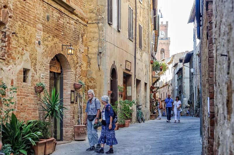 Couples enjoy an afternoon stroll on Corso il Rosselino in Pienza, Tuscany, Italy, 3 October 2011, Europe