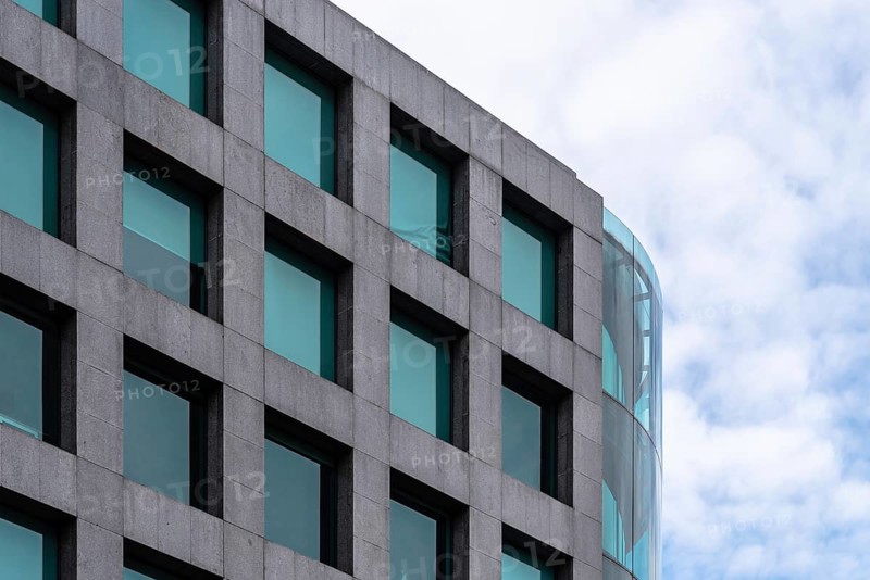 Madrid, Spain, October 16, 2021: Stone and glas ventilated facade of modern office building. Maria de Molina avenue, Europe