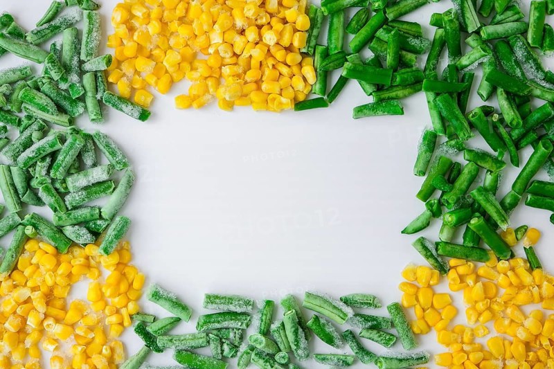 Frozen vegetables food background of yellow corn, green beans. Harvest Food preservation for winter. Veganism, vegetarian healthy eating, Empty copy space for text