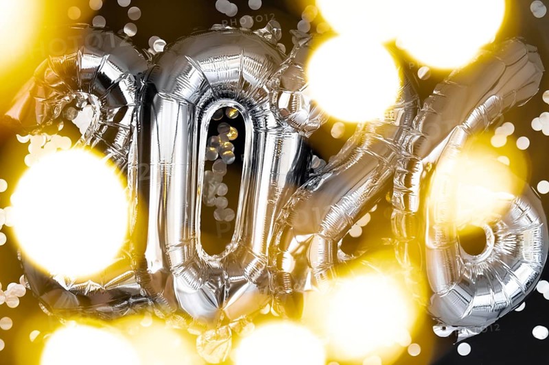 Holiday bokeh garland Happy new year 2026 metallic balloons with confetti on dark black background. Greeting card silver foil balloons numbers Christmas holiday concept. Celebration party congratulation decoration