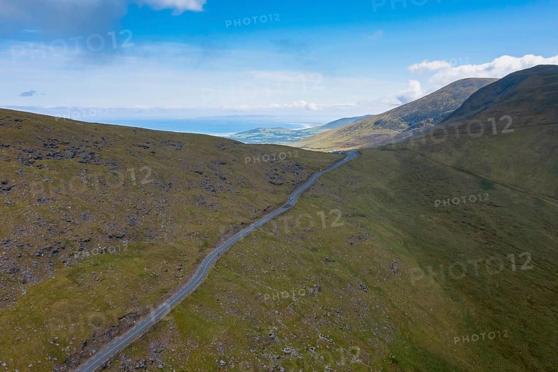 Landscape view with the steep mountain road leading to the top of Connor Pass on the Dingle Peninsula