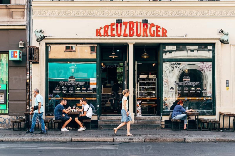 Berlin, Germany, July 29, 2019: Trendy restaurant with tables on sidewalk in Kreuzberg quarter. Kreuzberg is one of the cultural centers of Berlin, Europe