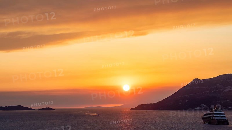 Cloudy atmosphere at sunset by the sea, view from the bell tower, cruise ship near Korcula, Korcula island, Dalmatia, Croatia, Europe