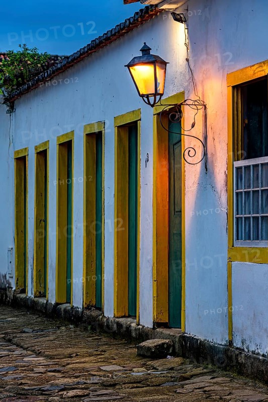 Dusk in the historic city of Paraty with colonial houses and facades illuminated by lanterns