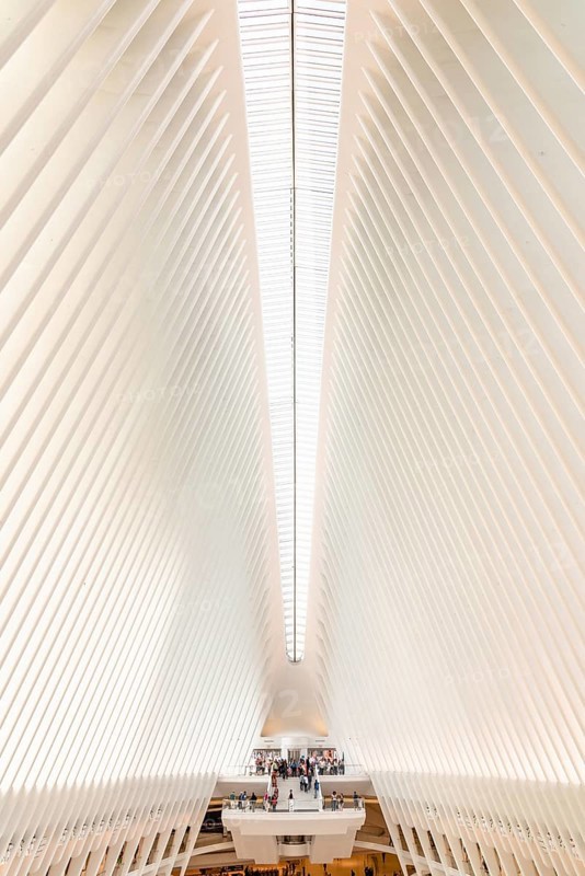 New York City, USA, June 24, 2018: Interior view of World Trade Center Transportation Hub or Oculus designed by Santiago Calatrava architect. Low angle view of white ceiling with abstract geometry of futuristic architecture building, North America