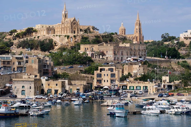 This bustling harbour full of fishing boats is the first place which greets visitors to Gozo, Mgarr, Malta, Europe