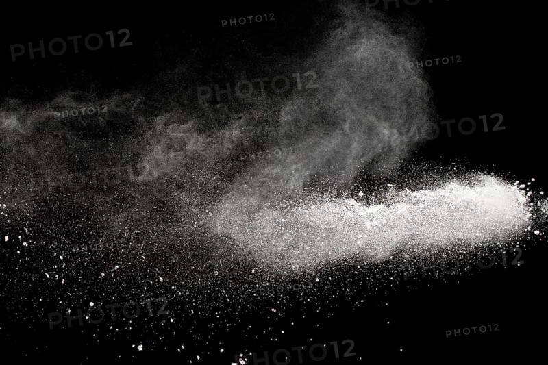 Bizarre forms of white powder explosion cloud against black background.White dust particles splash