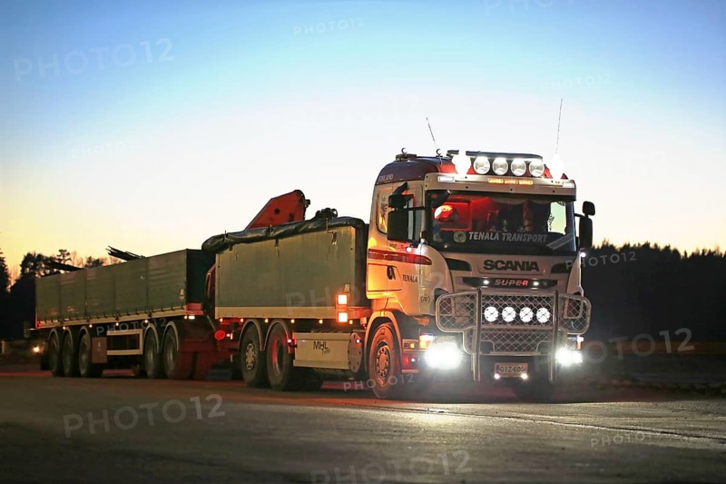 SALO, FINLAND, DECEMBER 6, 2016: Customized Scania truck of MHL-Trans with beautiful lights parked at a truck stop yard at dusktime