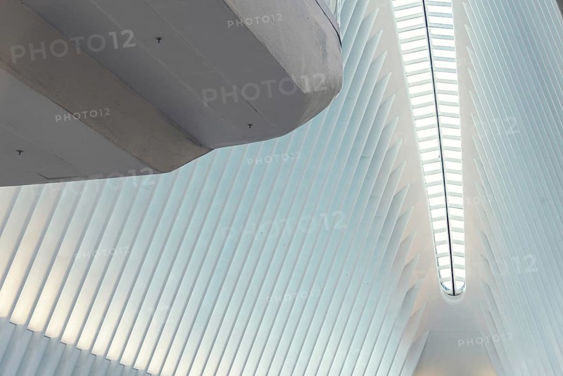 New York City, USA, June 24, 2018: Interior view of World Trade Center Transportation Hub or Oculus designed by Santiago Calatrava architect. Low angle view of white ceiling with abstract geometry of futuristic architecture building, North America