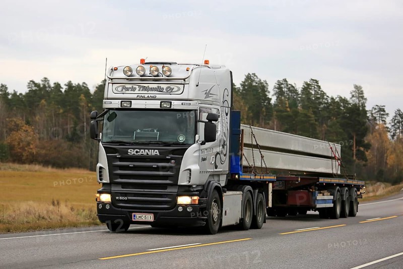 KAARINA, FINLAND, OCTOBER 23, 2016: Light Grey Scania R500 semi of Porin Tiehuolto Oy transports concrete beams along highway on a cloudy day of autumn