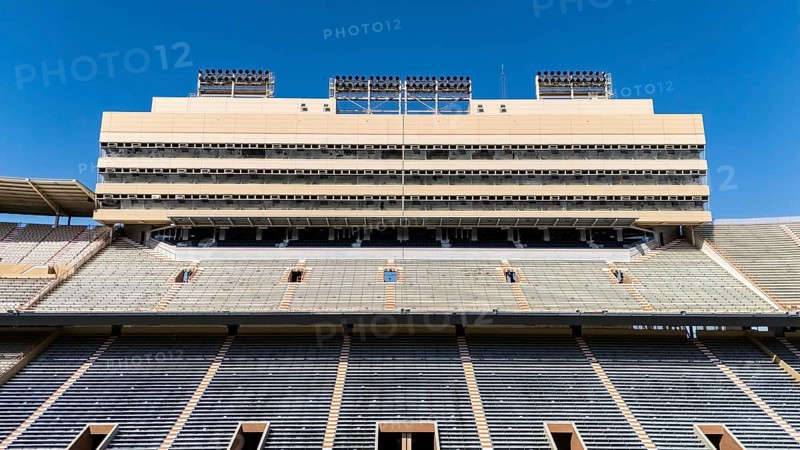An aerial view of Neyland Stadium reveals a massive, iconic structure nestled by the Tennessee River, with its distinctive bowl shape and seating for over 100, 000 fans, showcasing its rich football heritage