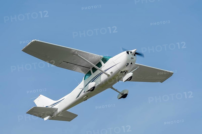 Single-engine sport airplane in a clear blue sky