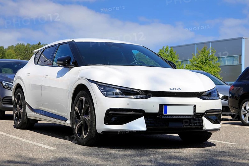 White Kia EV6 fully electric crossover car parked at the new car dealership. Salo, Finland. June 11, 2023