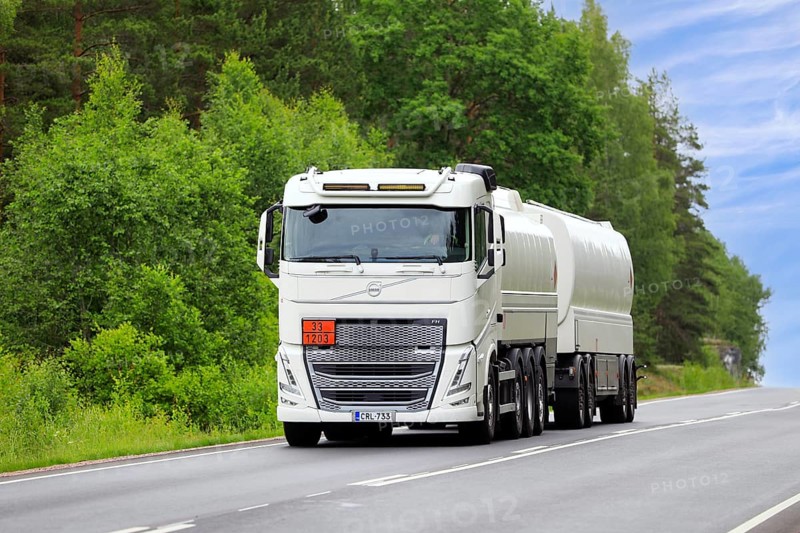 White Volvo FH tank truck transports gasoline fuel, ADR code 33-1203, on rural highway on a day of summer. Salo, Finland. June 19, 2024