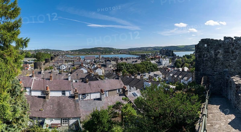 Conwy, United Kingdom, 27 August, 2022: view of the walled Welsh town of Conwy with the medieval castle and River Conwy behind, Europe