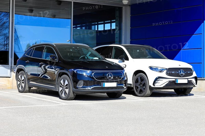 Black Mercedes-Benz EQA 250 battery electric SUV year 2023 and new white Mercedes-Benz 4matic SUV with diamond grill. Salo, Finland. April 10, 2023