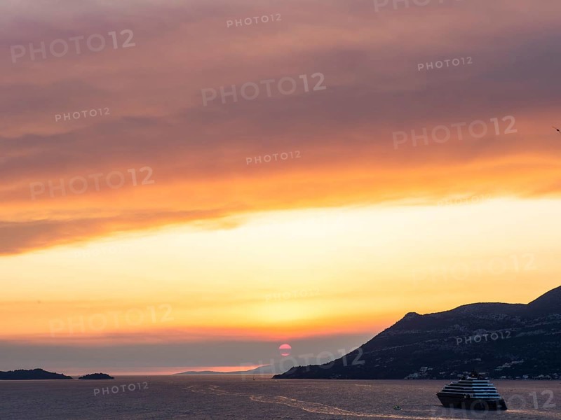 Cloudy atmosphere at sunset by the sea, view from the bell tower, cruise ship near Korcula, Korcula island, Dalmatia, Croatia, Europe