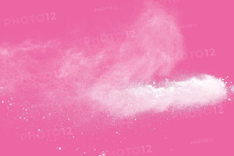 White powder explosion on pink background
