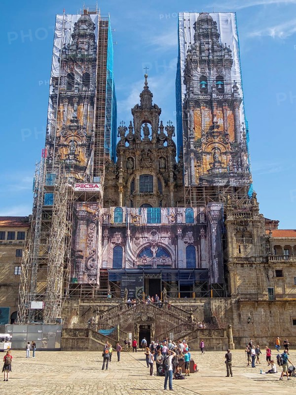 Western facade of the cathedral behind scaffolding and mural panels during restoration, Santiago de Compostela, Galicia, Spain, Europe
