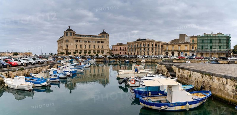 Syracuse, Italy, 28 December, 2023: colourful boats in the harbour between Syracuse and Ortygia Island, Europe