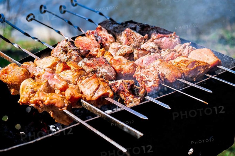 Meat is fried on coals. Camping, barbecue on the grill. Selective focus. Fried meat on charcoal BBQ Outdoor activities and healthy eating