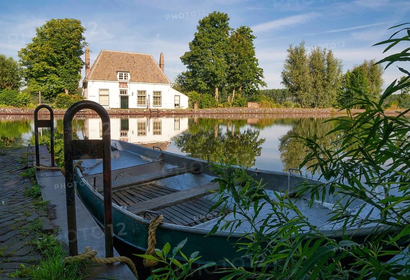 View over a rowing boat at the ferry house in Overschie along the canal Delftse Schie between the Dutch cities of Rotterdam en Delft