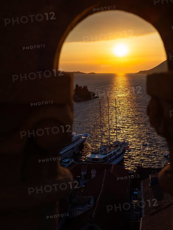 Evening atmosphere at sunset by the sea, view from the bell tower, ship in Korcula harbour, Korcula island, Dalmatia, Croatia, Europe