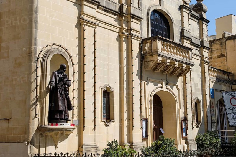 The life-size bronze statue of San ?or? Preca, the founder of the Society of Christian Doctrine as well as a Third Order Carmelite, on the façade of St James Church, Victoria, Malta, Europe