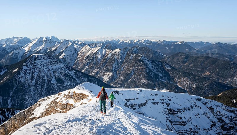 Two ski tourers at the summit of Schafreuter, view of snowy mountain panorama, Karwendel, Tyrol, Austria, Europe