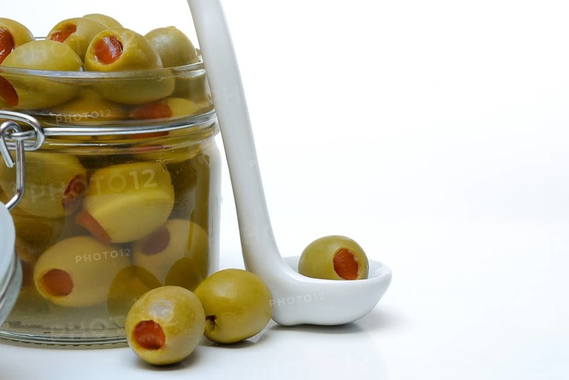 Green olive stuffed with pieces of paprika
