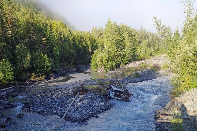 Wreckage of a car lying in a creek, Richardson Highway, Alaska, USA, North America