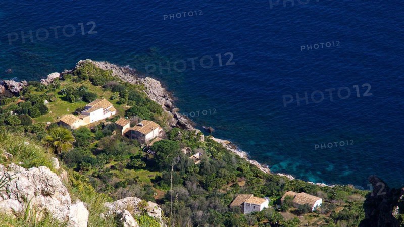 Coastline, houses, red tiled roofs, dark blue sea, Zingaro, national park, nature reserve, northwest, Sicily, Italy, Europe