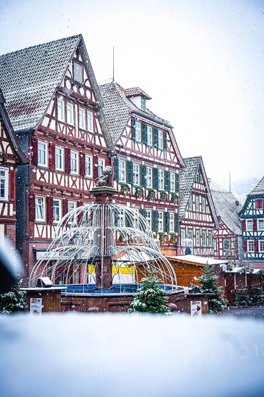 Half-timbered house backdrop on a snow-covered Christmas market with winter decorations, Black Forest, Calw, Germany, Europe