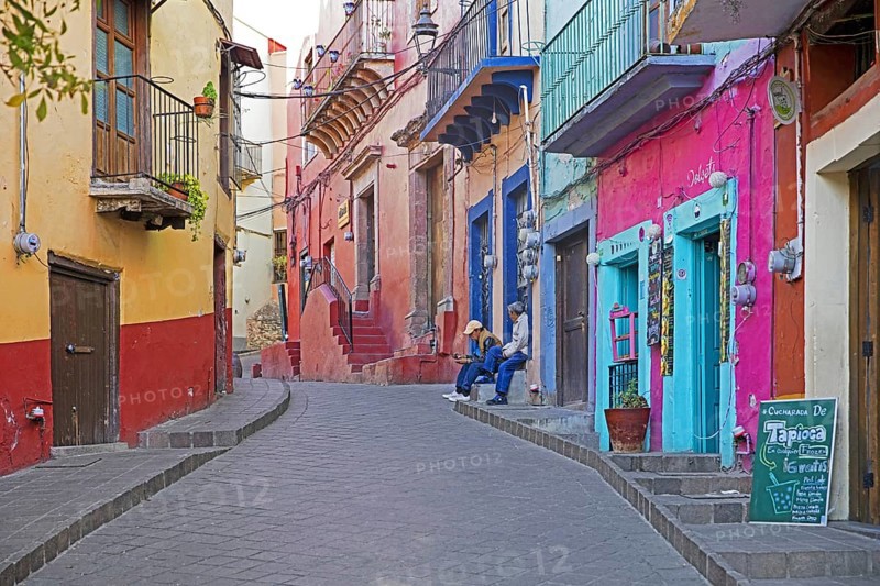 Colourful colonial era houses with balconies in alley paved with square cut stones in the city Guanajuato, Central Mexico