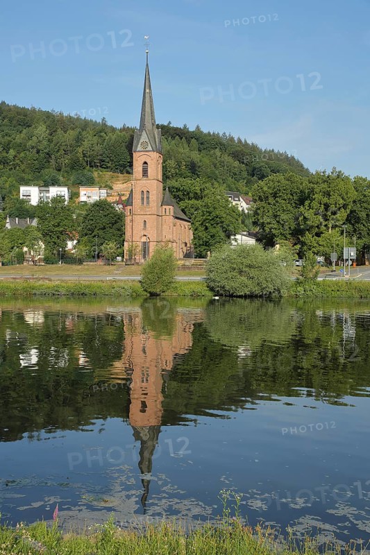 Neo-Gothic Protestant Church in Hirschhorn with Reflection in the Neckar River in Hirschhorn, Neckar Valley, Odenwald, Hesse, Germany, Europe