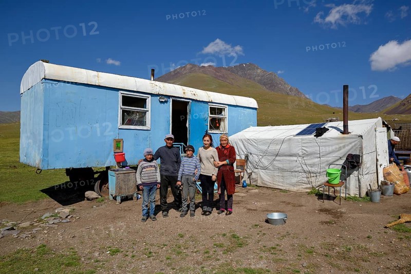 Shepherd family in front of their caravan on their summer pasture, West Karakol Valley, Tien Shan Mountains, Naryn Region, Kyrgyzstan, Asia