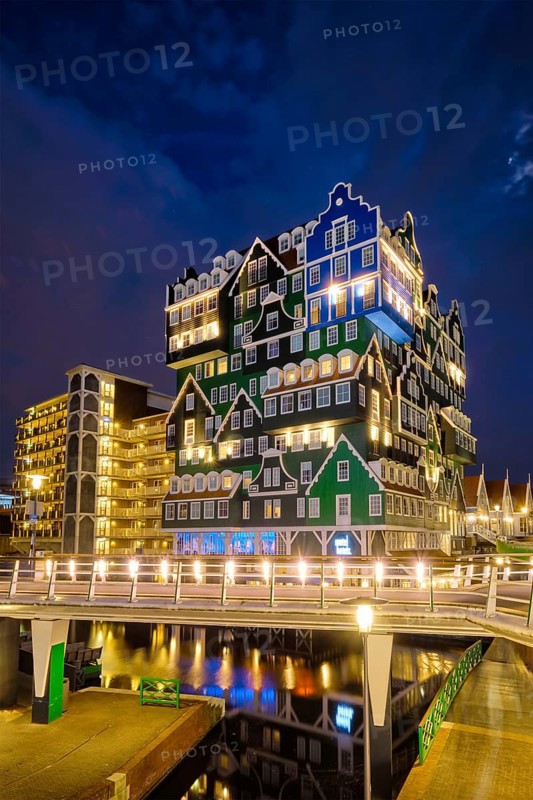 ZAANDAM, NETHERLANDS, MAY 21, 2018: Inntel Hotel in Zaandam illuminated at night. Design of 12-storey tall building opened in 2009 is the result of stacking a series of traditional Dutch houses