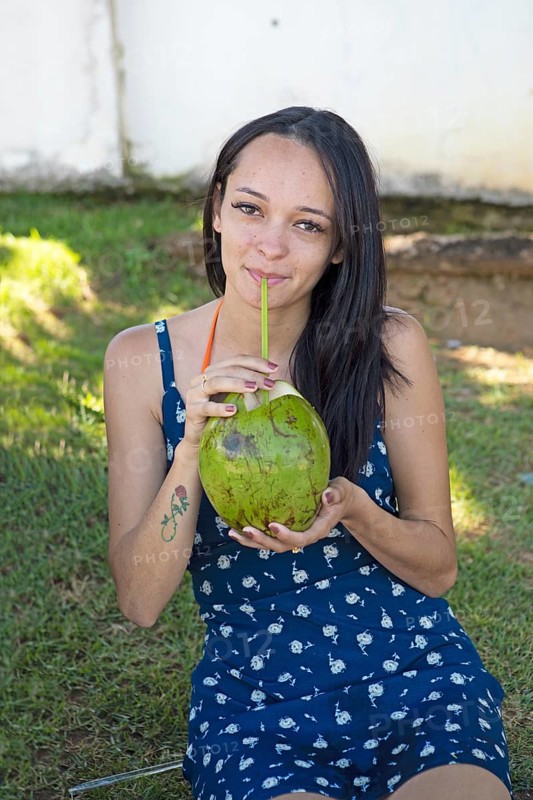 Brazilian woman, 26, drinking from coconut, Salvador, Bahia State, Brazil, South America