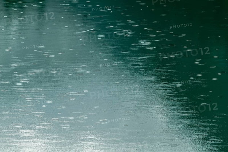Raindrops on emerald green reservoir, Stillup reservoir, Stilluptal, Mayrhofen, High Mountain nature park Park Zillertal Alps, light reflections, Tyrol, Austria, Europe