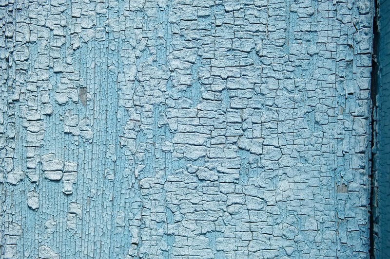 Abstract wooden background. Cracked paint on the wall
