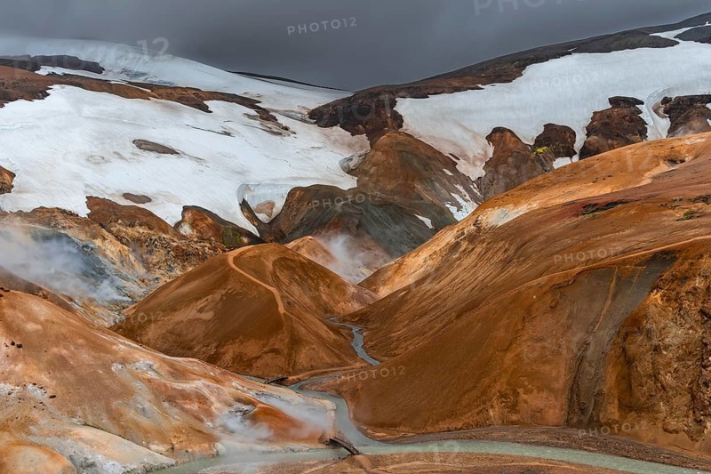 Bridge and steaming streams between colourful rhyolite mountains with snowfields, Hveradalir geothermal area, Kerlingarfjöll, Icelandic highlands, Iceland, Europe