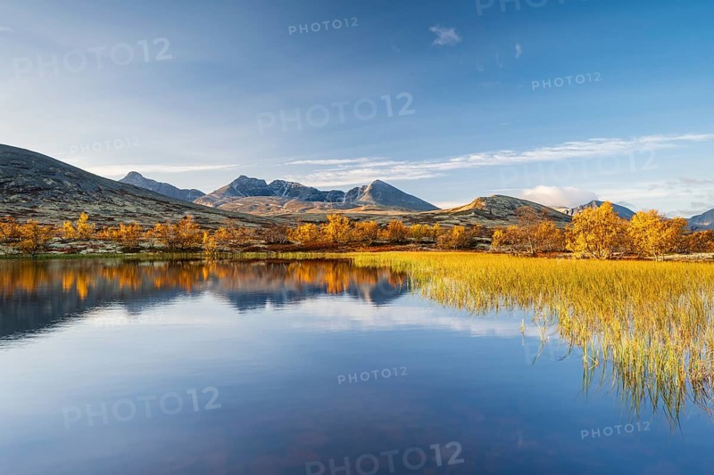 Reflection of the autumn landscape in Rondane National Park, mountains Høgronden, Midtronden and Digerronden Dørålen, Dørålseter, Norway, Europe