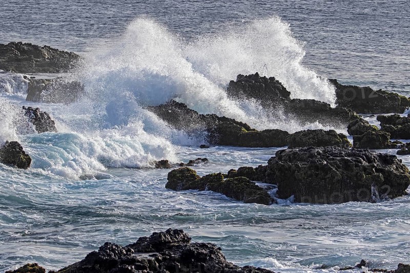 Waves breaking on volcanic rocks in the surf at the headland Ponta Temerosa on the island Santiago, Cape Verde, Cabo Verde, Africa