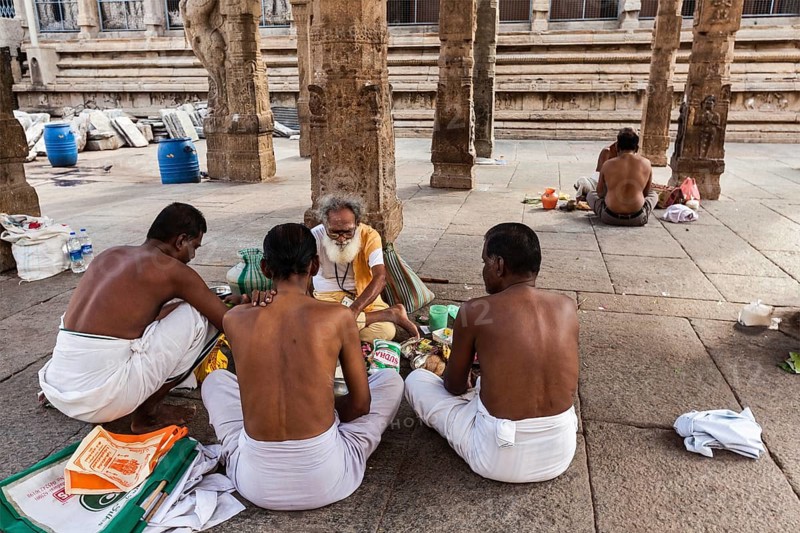 MADURAI, INDIA, FEBRUARY 16, 2013: Indian brahmin (traditional Hindu society) priest and pilgrims in famous Meenakshi Amman Temple, historic Hindu temple located in temple city Madurai