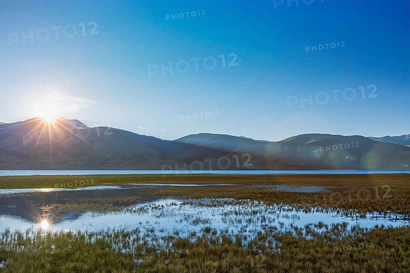 Lake Tso Moriri in Himalayas on sunrise. Ladakh, Inda. With lens flare