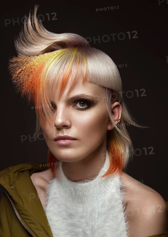 Portrait of beautiful woman with multi-colored hair and creative make up and hairstyle