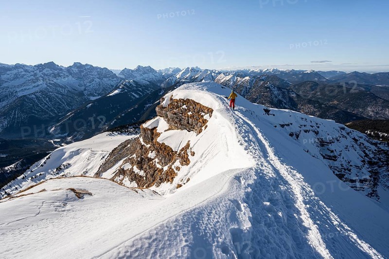 Ski tourers at the summit of Schafreuter, view of snow-covered mountain panorama, Karwendel, Tyrol, Austria, Europe