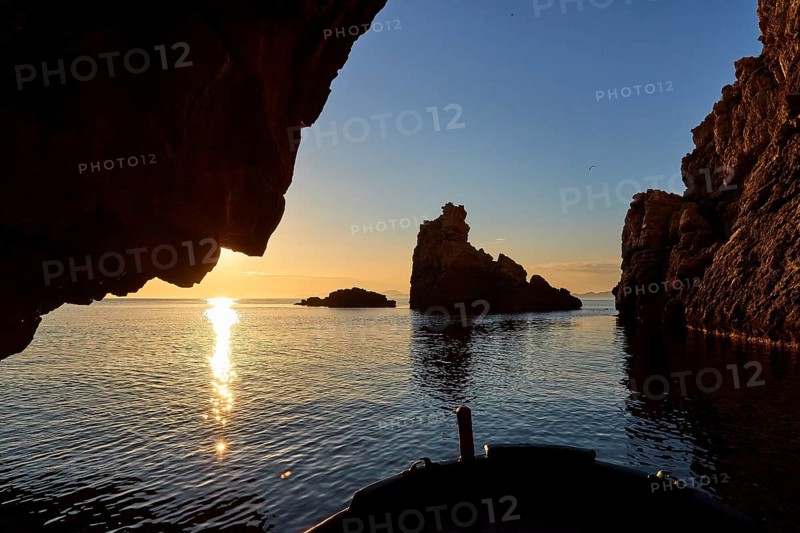 Grotta del Camello, morning light, boat tour, sunrise, sun as star, backlight, Marettimo, Egadi Islands, Sicily, Italy, Europe