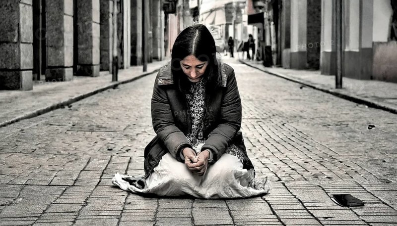 Social hardship, Torn beggar woman with poor clothes in humble posture kneeling on the street, KI generated, AI generated