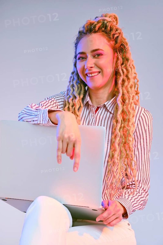 Smiling young woman shows the comfortability of using wireless technology
